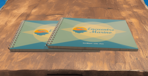 Encuentro Marino menus sitting on a wood table in a seafood restaurant with rustic and simplistic decor