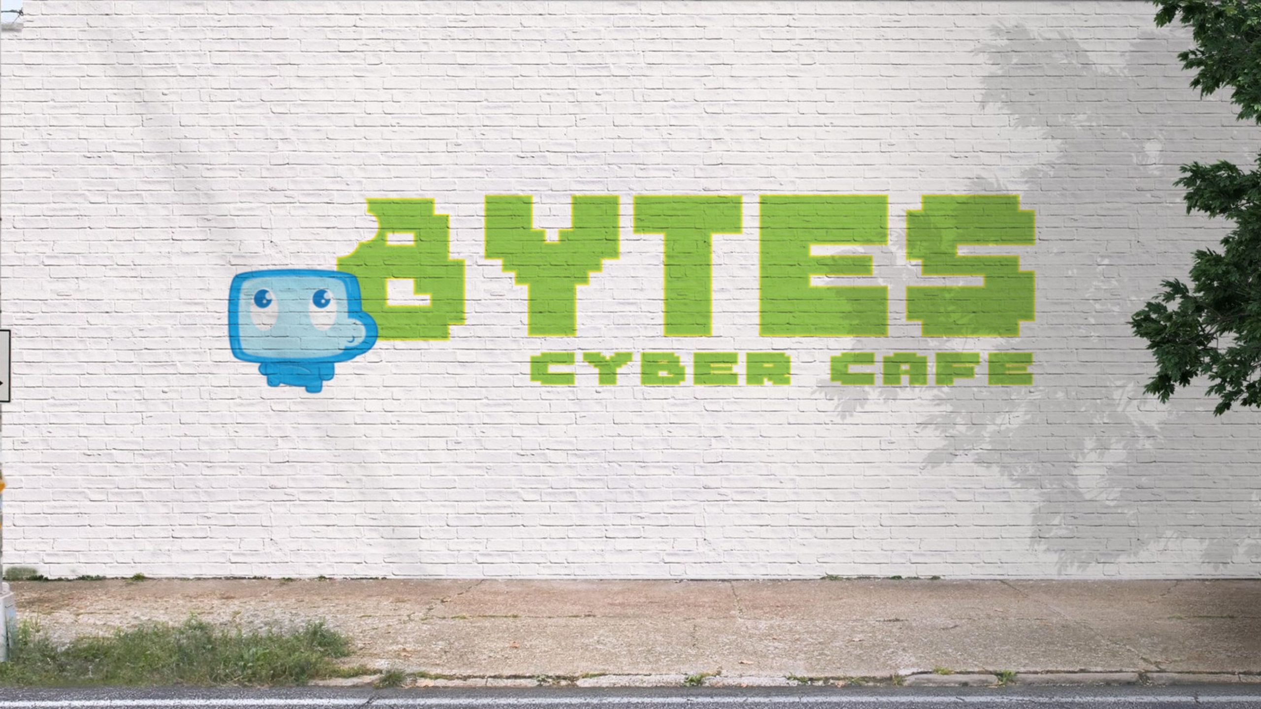 Bytes Cyber Cafe logo advertising on a white brick wall